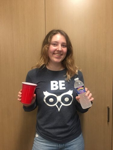 Be Wise peer educator Brittany holding a red solo cup and bottle of water