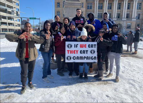 A multicultural student organization poses together during a volunteer evetn