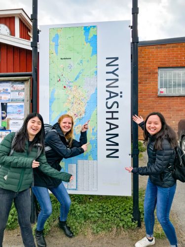 Danielle and friends in front of a map of Nynäshamn 