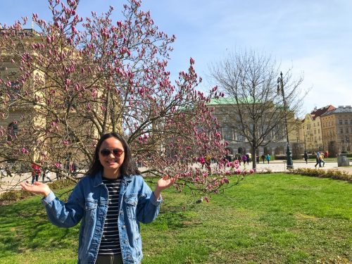 Danielle poses with a cherry blossom in Prague