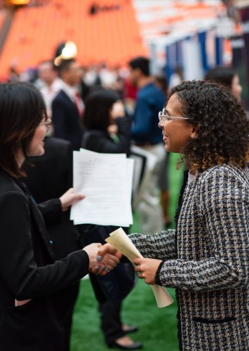 A student shakes hands with a recruiter at the 