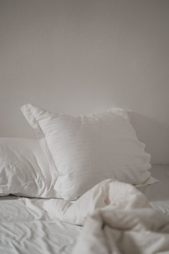 A bed made up in white linen 