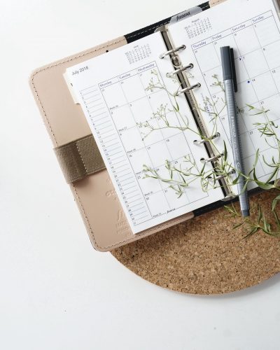 A monthly planner on a desk. 