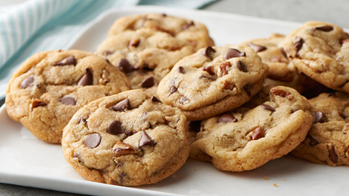 A plate of chocolate chip and walnut cookies