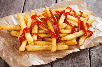 A stack of crispy french fries with ketchup