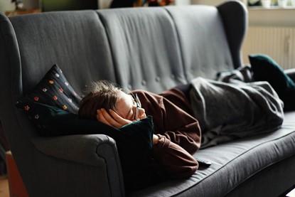 A person relaxing on a couch.