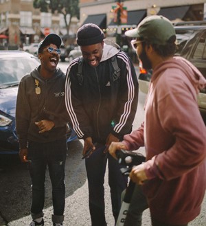A group of friends laugh while hanging out downtown.