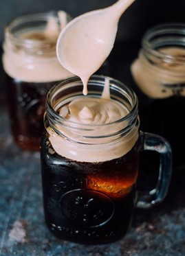 Cold brew coffee with freshly-whipped pumpkin cold foam in a mason jar.