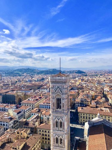 An electric blue sky cascades over the Florence city skyline