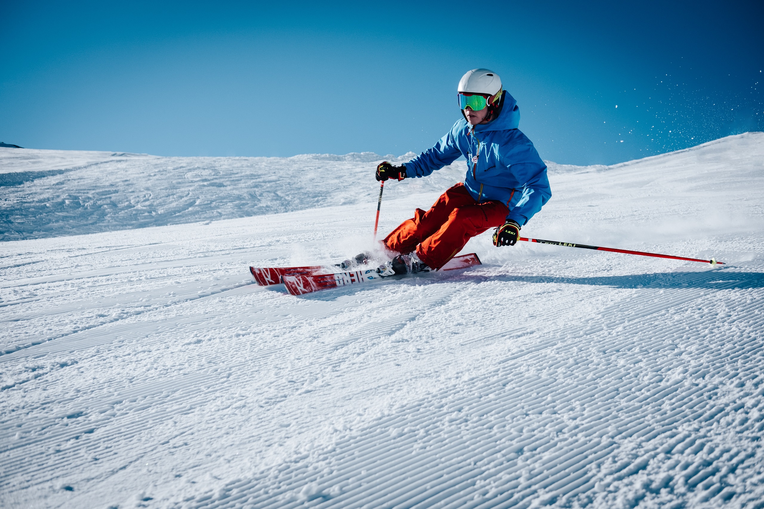 A person skis down a snowy mountain