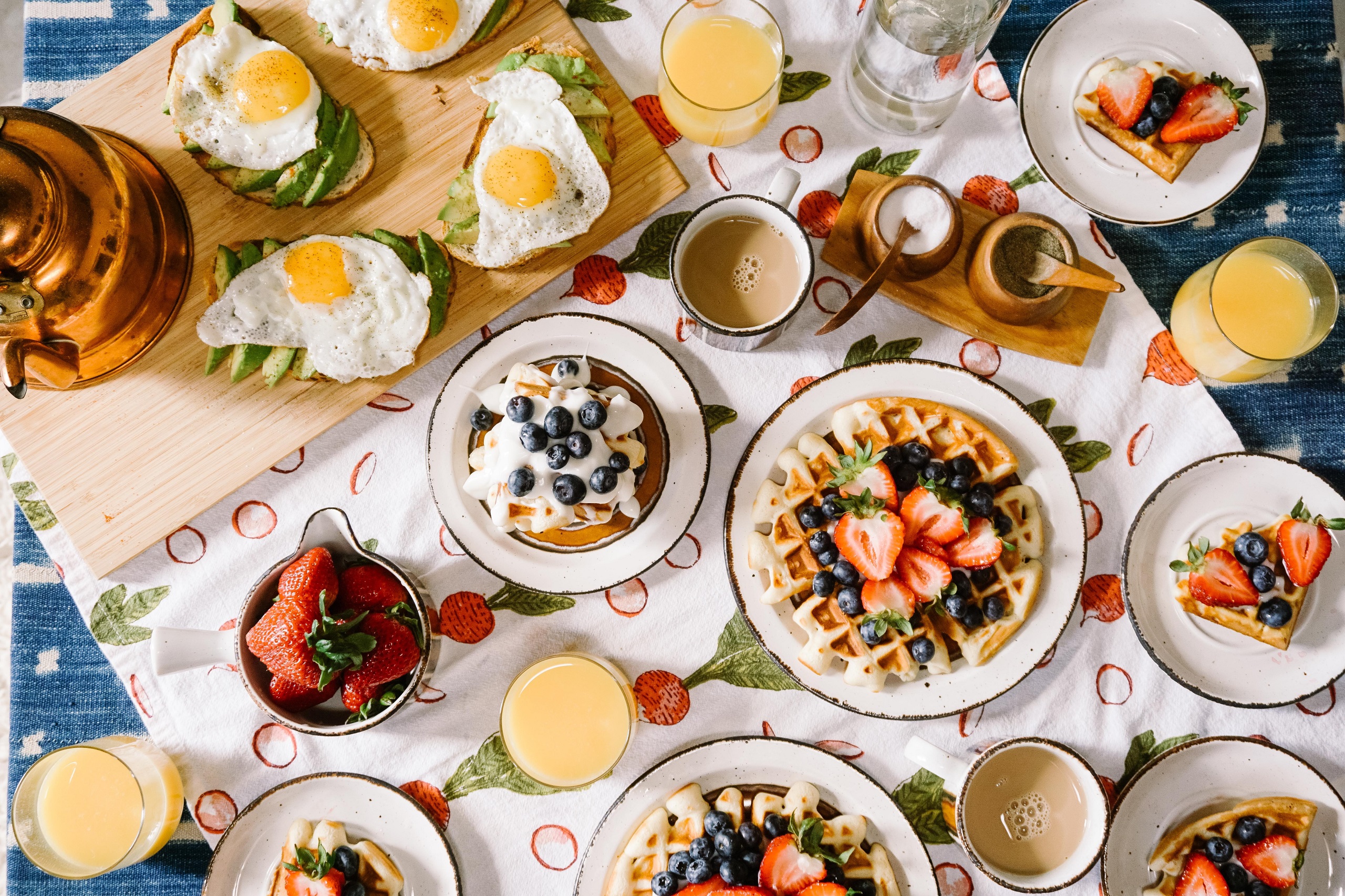 An overhead shot of a table full of different breakfast foods