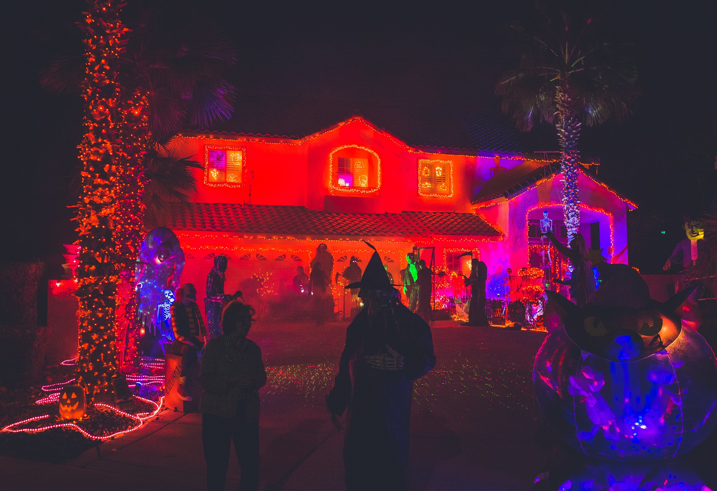 Trick-or-treaters outside a house decorated for Halloween