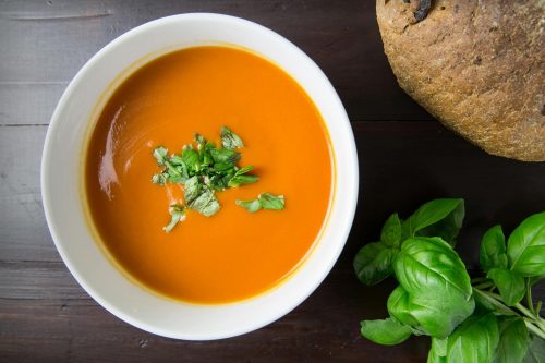 Tomato soup garnished with an herb.