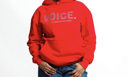 A model wears a bright red VOICE sweatshirt.