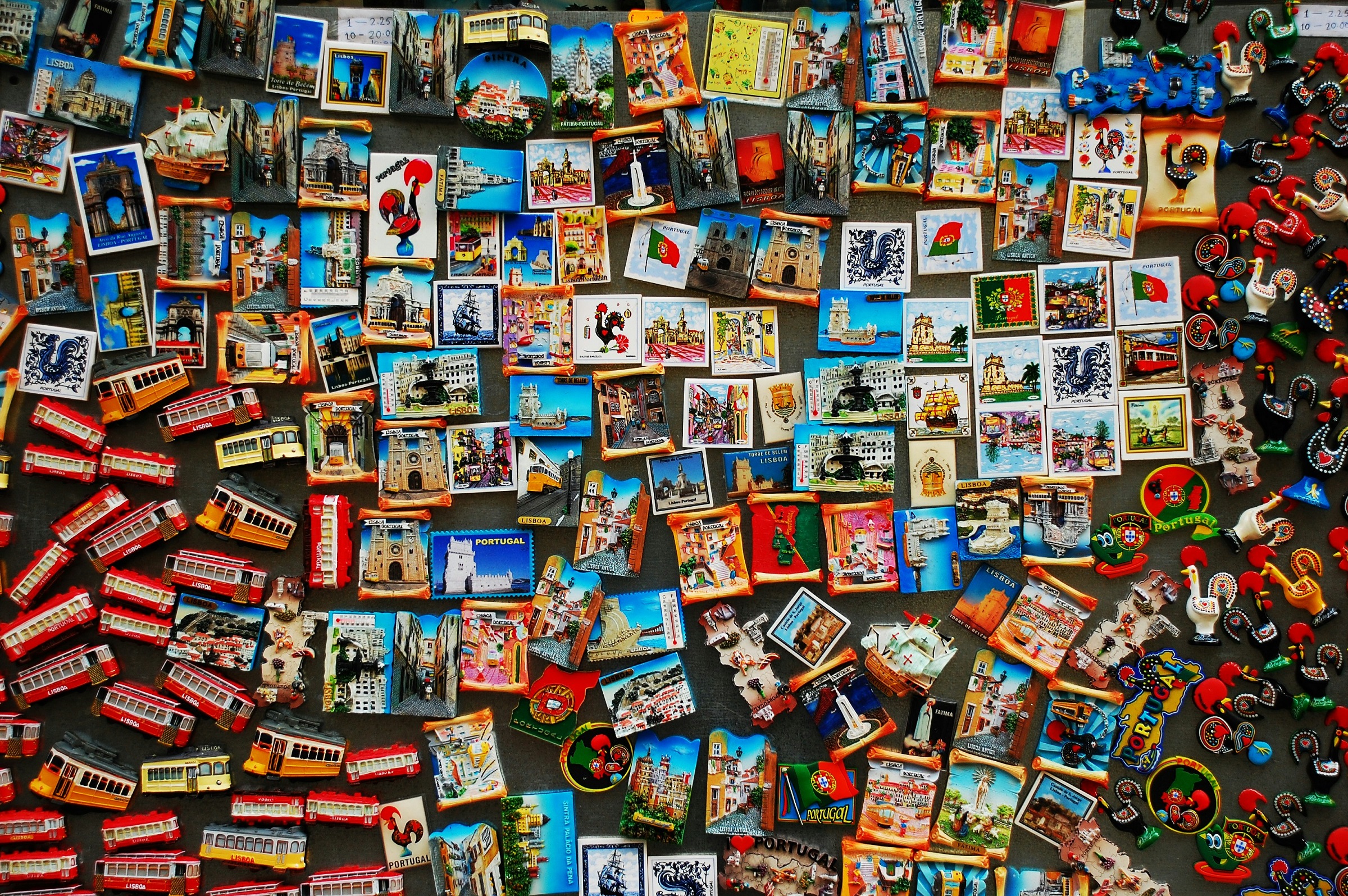 A wall of magnets depicting various locations and tourist destinations.