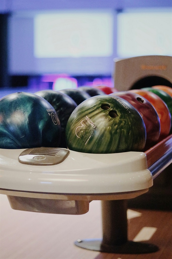 Bowling balls in a ball returner at a bowling alley