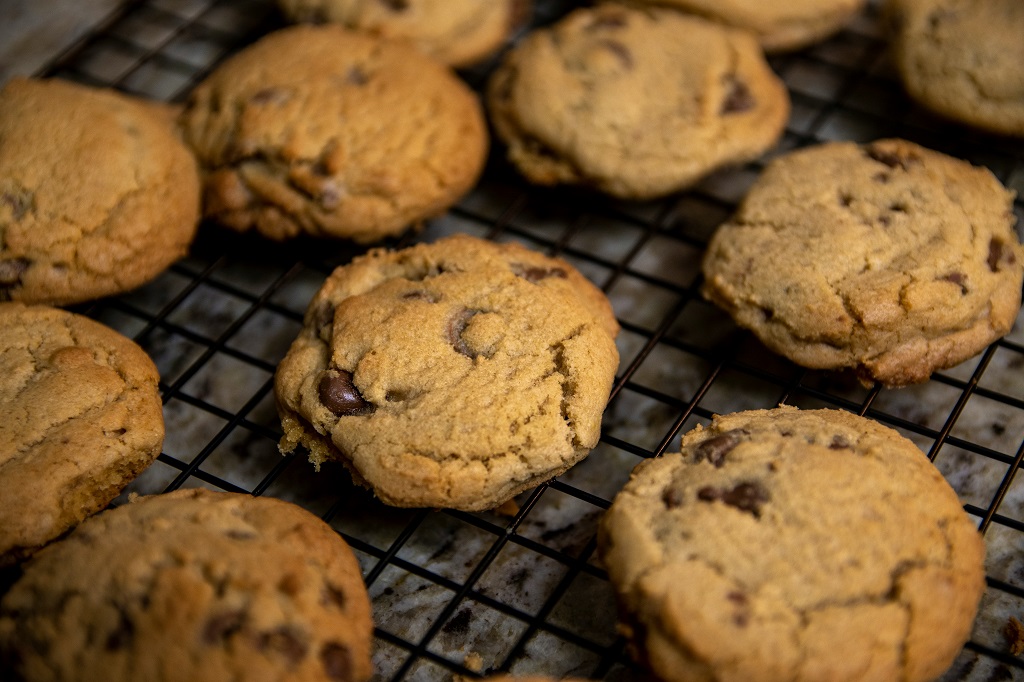 Chocolate chip cookies cool on a rack