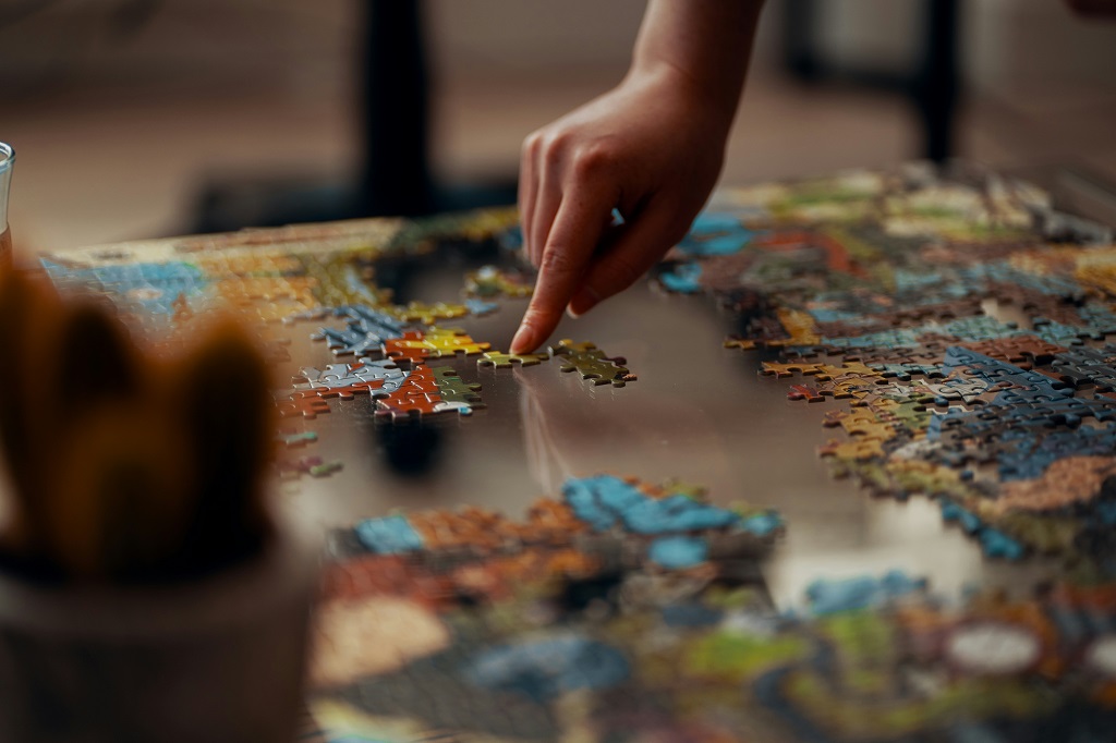 A person works on a jigsaw puzzle