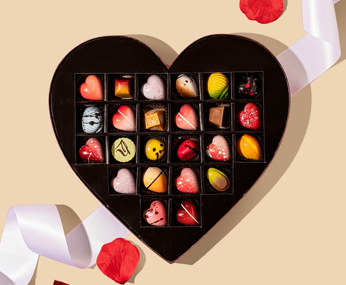 Fancy decorated chocolates in a heart-shaped chocolate box