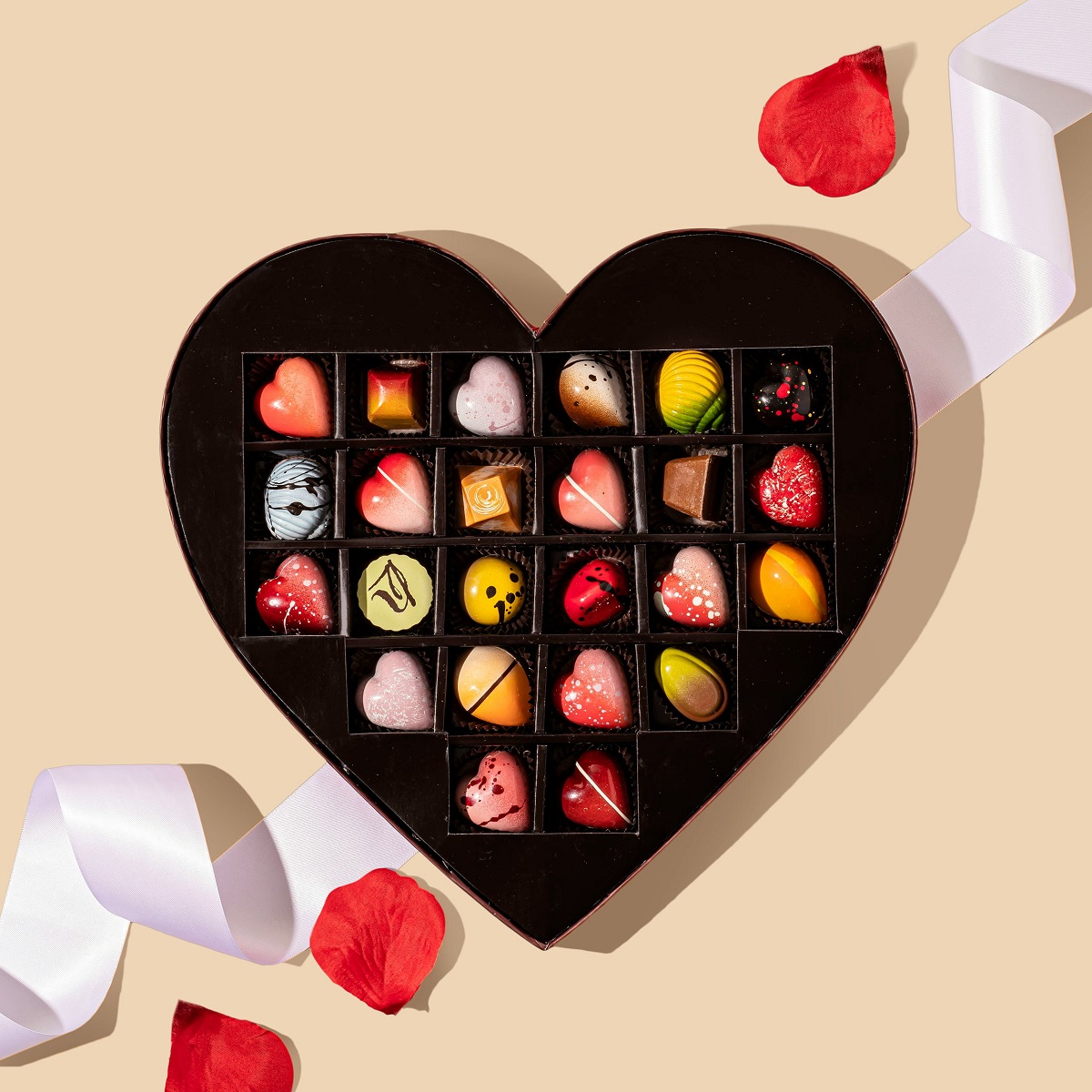 Fancy decorated chocolates in a heart-shaped chocolate box