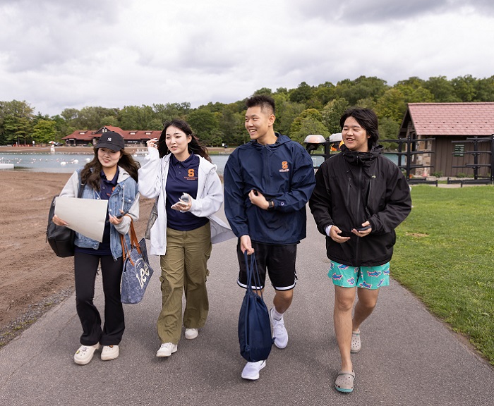 Four students walk along a path in Greek Lakes State Park