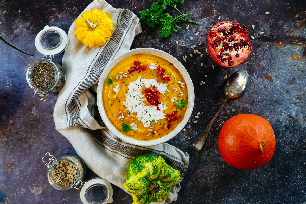 A fancy bowl of soup surrounded by various ingredients.