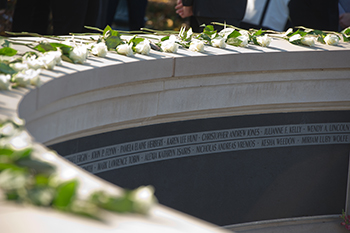 White roses rest on the Place of Remembrance.