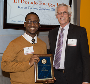 Kiven Pierre receives an award from Terry Brown, director of the Falcone  Center for Entrepreneurship, during the Panasci Business Plan Competition.