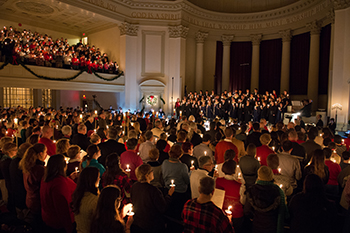 Concertgoers hold candles and sing "Silent Night" at the end of the Holidays at Hendricks concert.