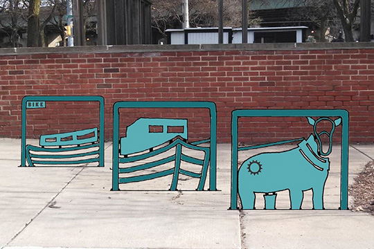 The conceptual design for the Erie Canal Museum bike rack set, placed where it would go in the Canal Museum public plaza