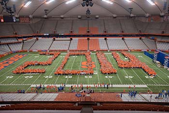Members of the current graduating class form the year of their graduation in the Carrier Dome during orientation in their freshman year.