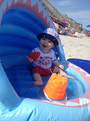 Colin McLean, 9 months old, son of Jeff McLean (graduate student in the math department/School of Education) and Lindsey McLean (staff member in the School of Architecture) enjoys the beach in Surf City, N.C.