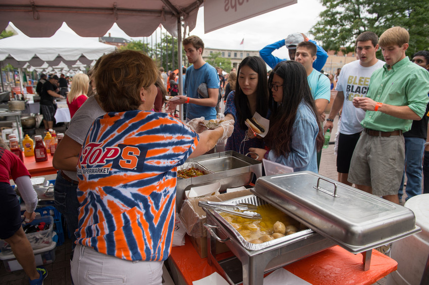 Students enjoy samples of delicacies from local restaurants during Citrus in the City in downtown Syracuse.