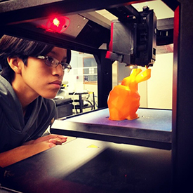 A student gets a close-up look at 3D printing.