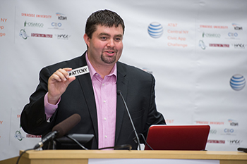 Seth Mulligan, vice president of innovation services at CenterState CEO, promotes the hashtag for the AT&T Central New York Civic App Challenge during a launch event Thursday morning at the The Tech Garden in downtown Syracuse.