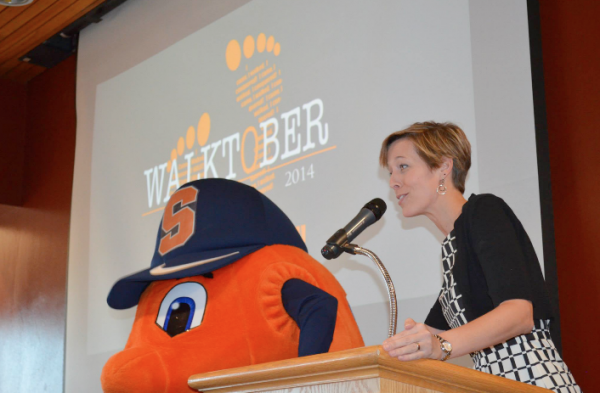 Lerner Center for Public Health Promotion Program Director, Rebecca Bostwick receives assistance from Otto in announcing the 2014 Walktober winners