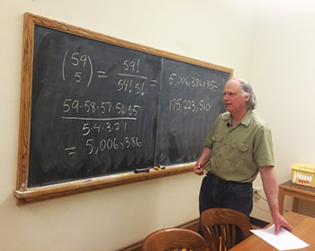 Professor of Mathematics Steven Diaz works on the equation to determine probability of winning the Powerball jackpot.
