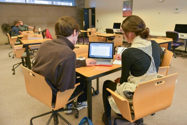 Two people looking at computer