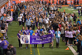 Participants march at the beginning of last year's Relay for Life in the Carrier Dome.