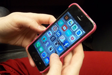 pink iphone in hands of user