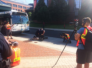Students from The NewsHouse videotape an emergency drill staged along College Place.