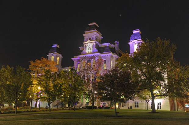 The Hall of Languages is lit up in purple in a previous year to "Shine the Light on Domestic Violence."
