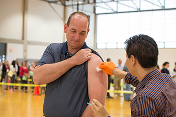 An employee receives a flu shot at one of last year's clinics.