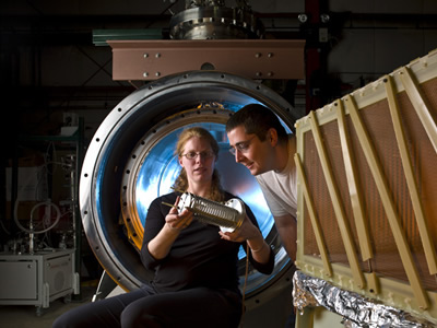 Mitchell Soderberg and Yale physicist Bonnie Fleming inspect a prototype of the MicroBooNE detector at Fermilab (Courtesy of Fermilab) 