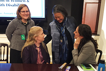 Arlene Kanter, standing at left, converses with (clockwise from upper right) Tina Chen, chief of staff to the First Lady; Caroline Bettinger-Lopez, White House Advisor on Violence against Women; and Stephanie Ortoleva, president of Women Disabled International Inc.