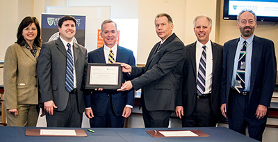 Administrators from both institutions gather to mark the partnership. From left are: iSchool Assistant Dean Susan Corieri, MU Provost David Dausey, MU President Michael Victor, iSchool Interim Dean Jeffrey Stanton, Ridge College Dean James Breckenridge and Ridge College Associate Dean Randall Clemons.