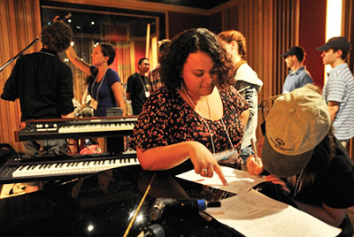 Music education students work with students who have intellectual disabilities to record music at Subcat Studios. 