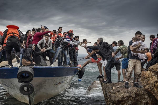 Oct. 11, 2015 - Lesbos Island, Greece - Refugees and Migrants aboard fishing boat driven by smugglers reach the coast of the Greek Island of Lesbos after crossing the Aegean sea from Turkey.