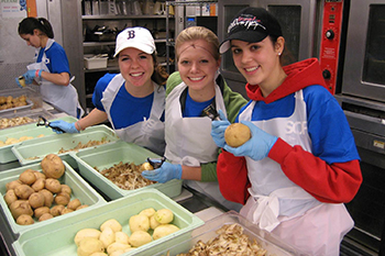 Students work in the kitchen of a nonprofit agency during a previous alternative Spring Break program.