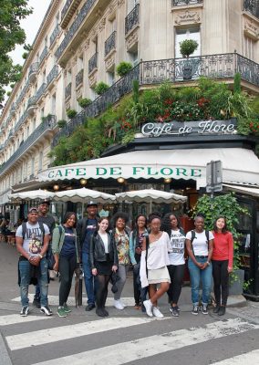 students in front of a cafe